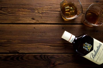 Outdoor bar top ideas - rustic wood, as picture here with a whiskey liquor bottle and shot glasses