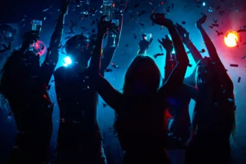 People dancing at a glow party - One of the bar theme nights