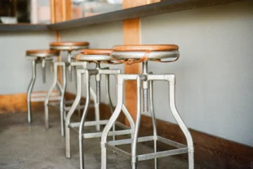 Many of the best metal bar stools are made of mixed materials, like these which have a metal frame and a cushioned seat