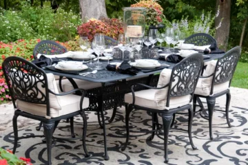 A white and blue rug beneath an outdoor dining set - How to clean an outdoor rug
