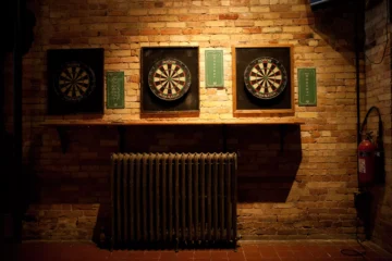 The best dart boards include classic bristle boards, as shown here hanging along a brick wall