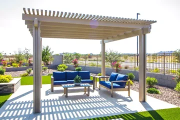 Pergola anchored to concrete patio with blue patio furniture - Best Pergola for High Winds