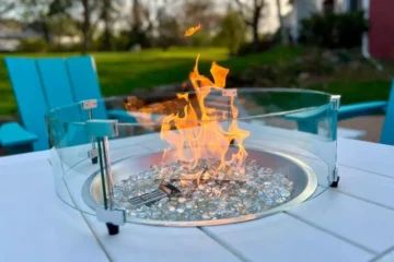 A glass wind guard surrounding an open flame - The best propane fire pit